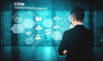 Business professional analyzing CRM customer relationship management dashboard with digital icons for sales, marketing, and client engagement.