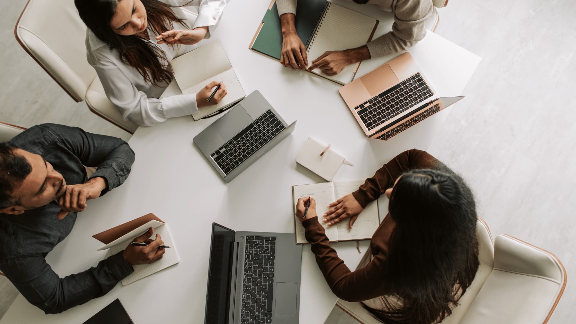 Top view of a business team working together with laptops and notebooks during a strategy meeting