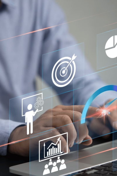Business professional using CRM software dashboard with digital marketing analytics and sales performance icons on laptop.