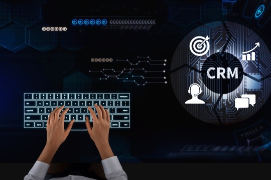 Hands typing on illuminated keyboard with CRM system interface showing customer support, sales growth, and marketing automation icons.
