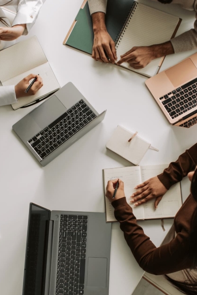 Top view of a business team working together with laptops and notebooks during a strategy meeting